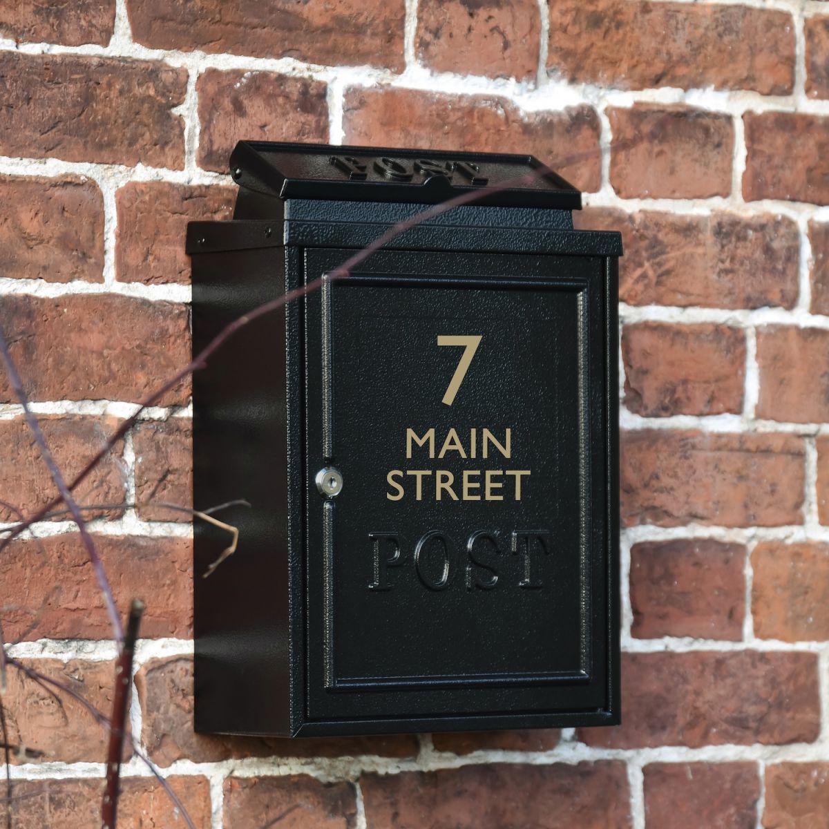 Angled view of black personalised wall mounted mail box