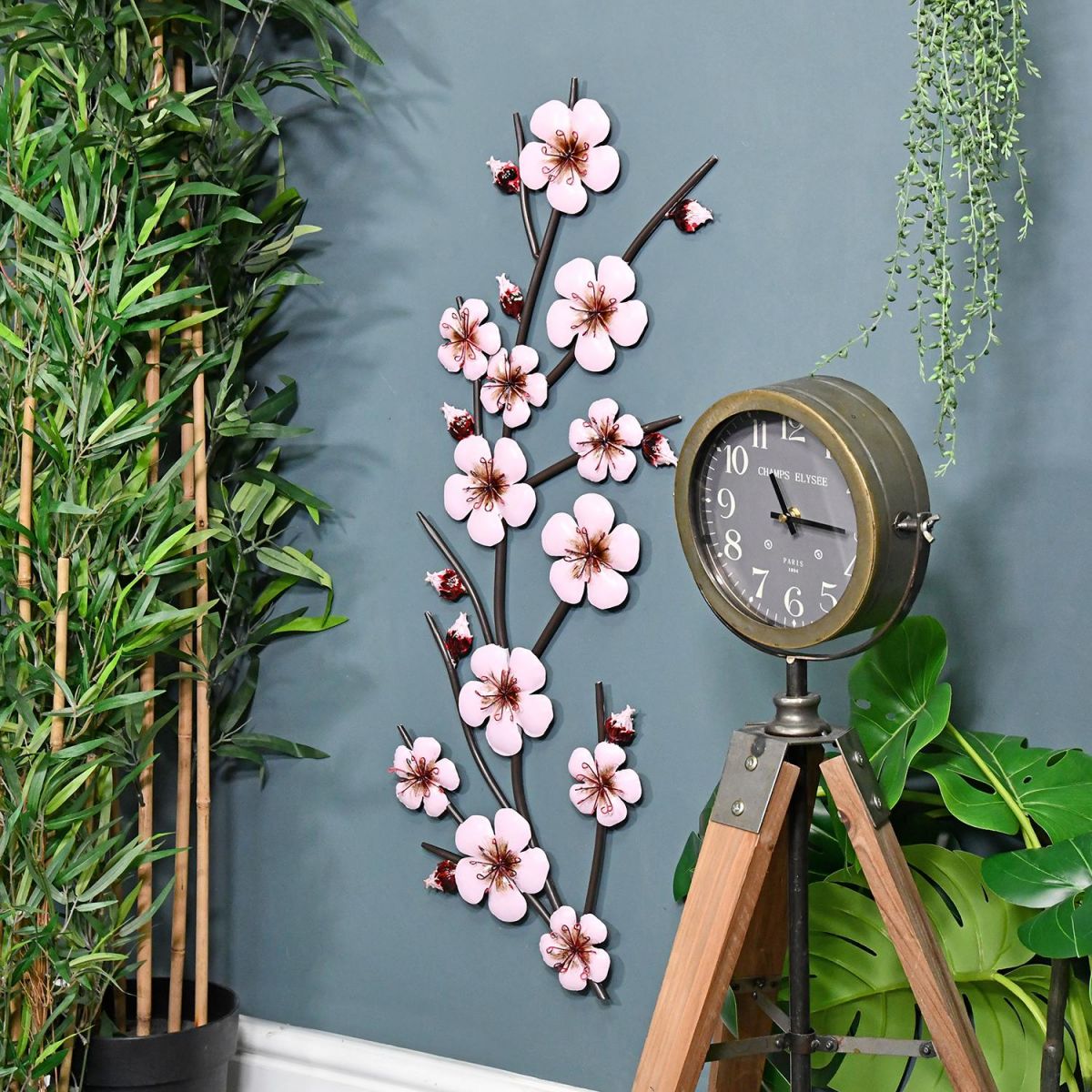 Pink Blossoms Metal Wall Art on Display on a Blue Wall