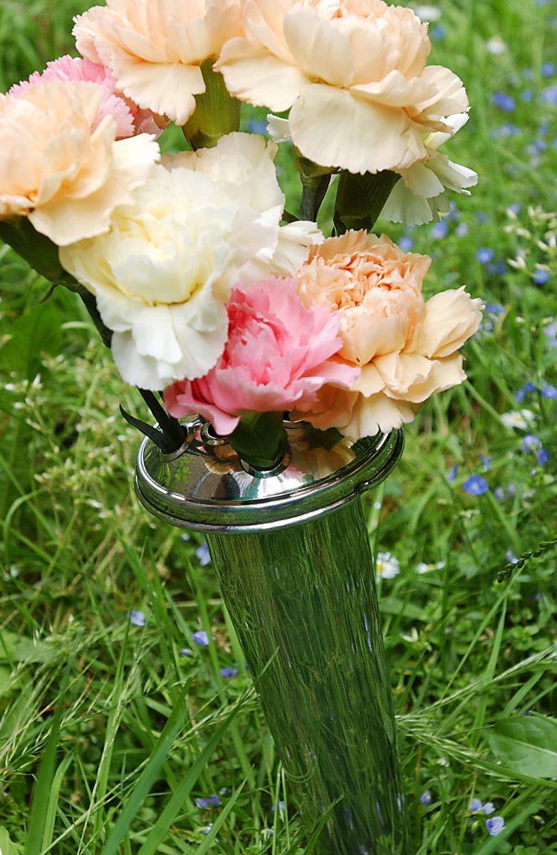 Aluminium conical vase in use in graveyard