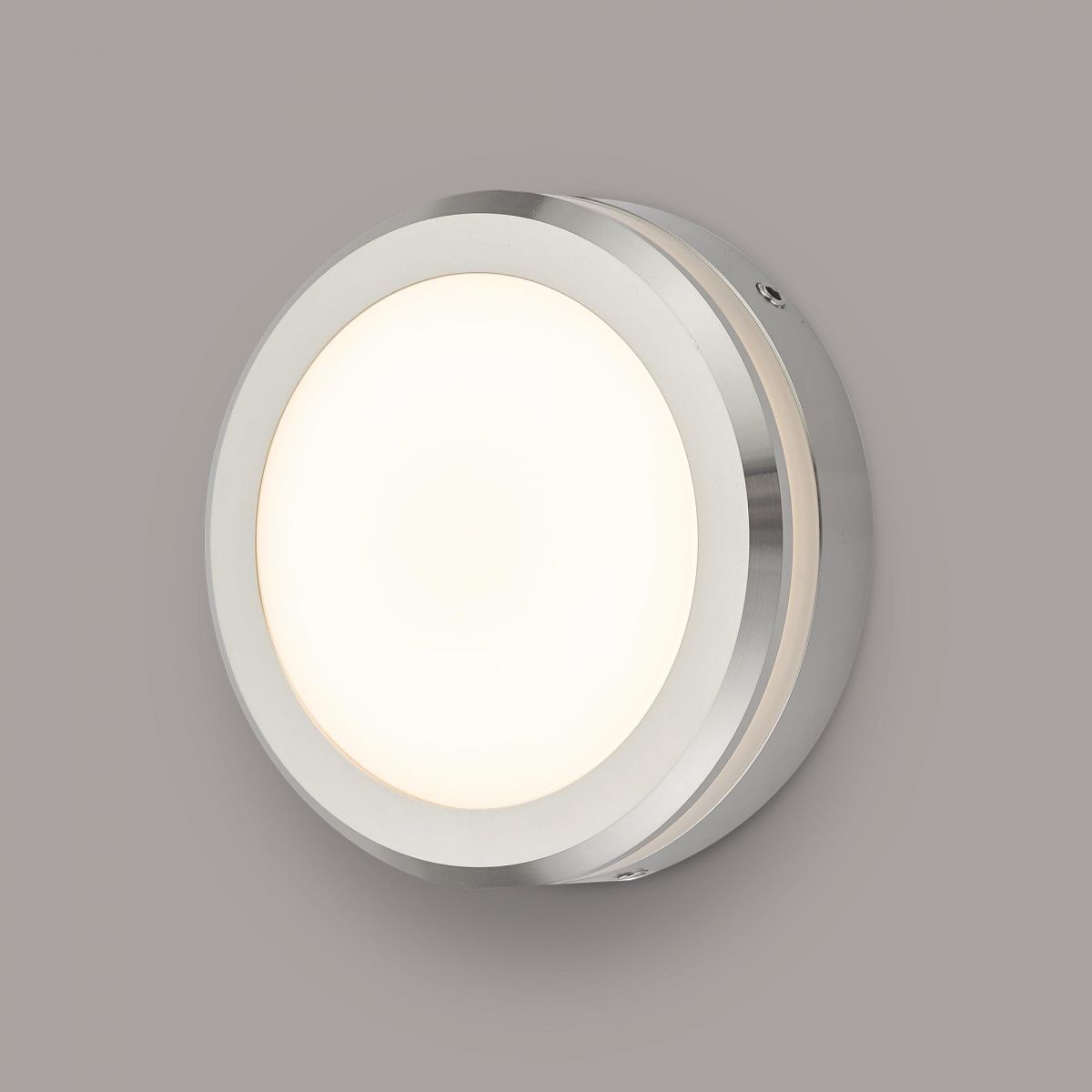 Polished Aluminium Round Wall Light in Situ on a Grey Wall