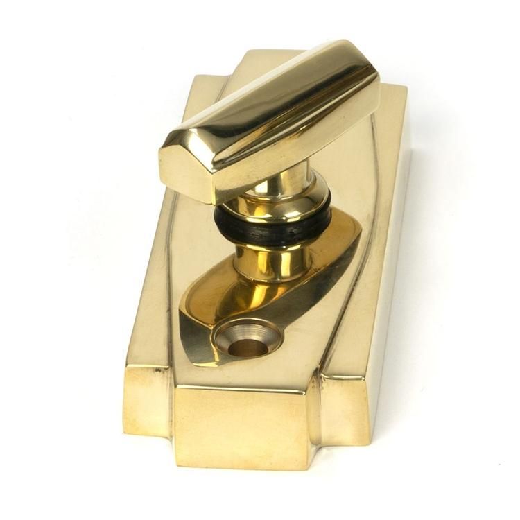 Close-Up of Polished Brass Art Deco Bathroom Thumb Lock