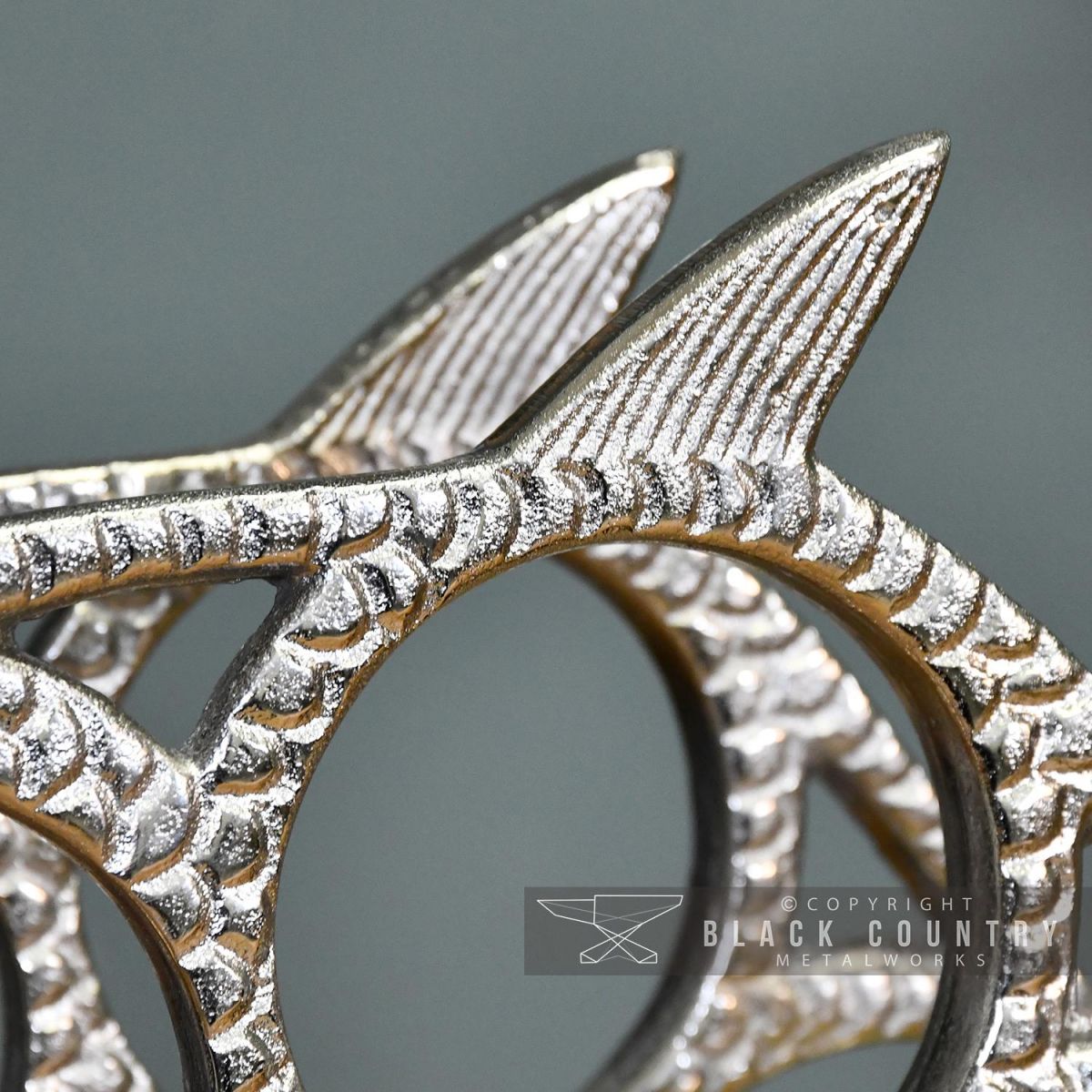 close-up of the Detail on the Polished Nickel "Fish" Wine Rack 