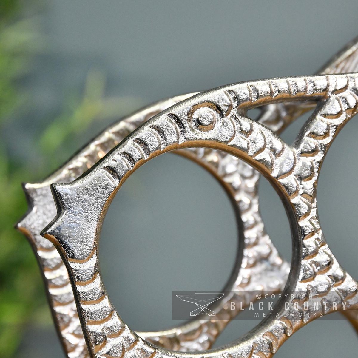 Close-up of the Face on the Polished Nickel "Fish" Wine Rack of the 