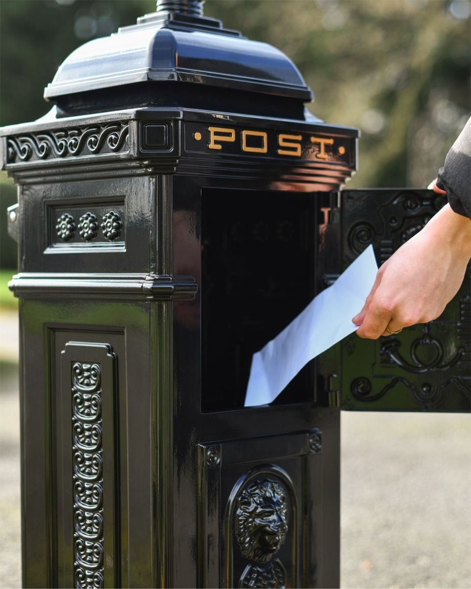 Black Post Box With Letter Being Posted 
