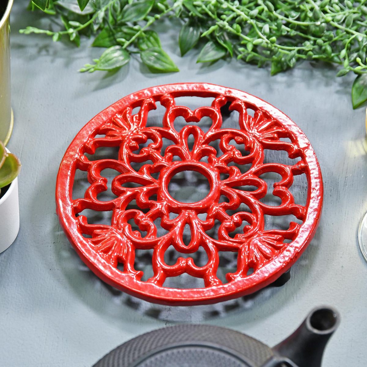 Red Heavy Duty Cast Iron Round Trivet in Situ on a Table