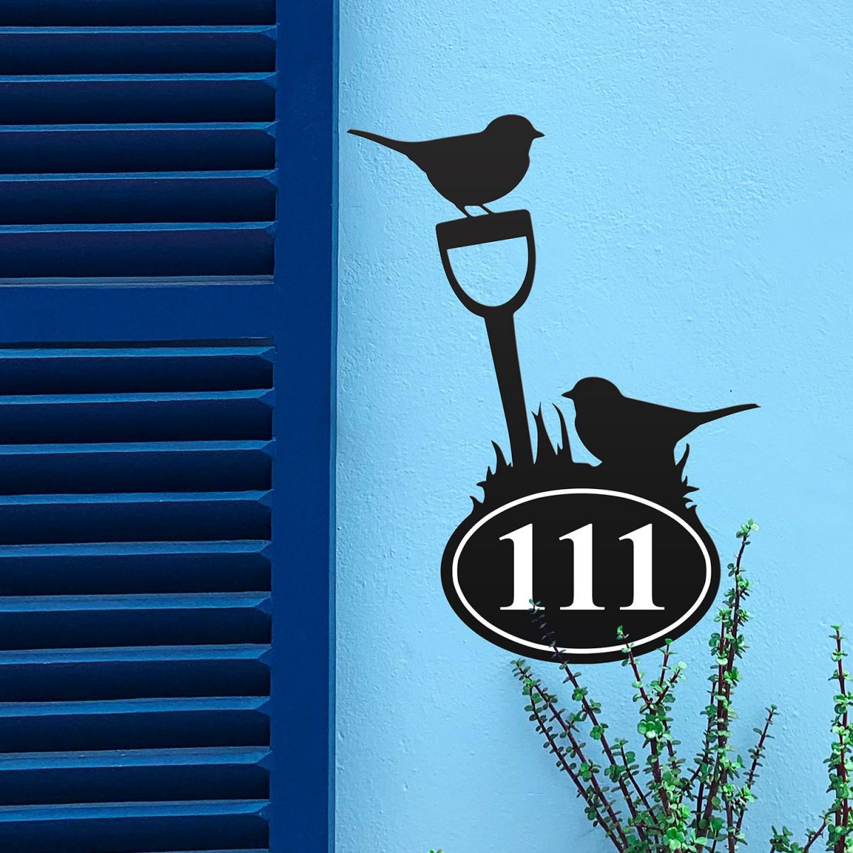 Robin Iron House Number Sign in Situ on a Blue Wall 