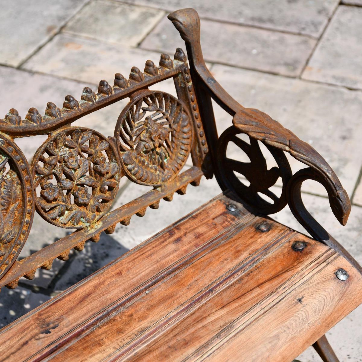 Close up of Rustic Cast Iron Garden Bench with Wooden Slats 