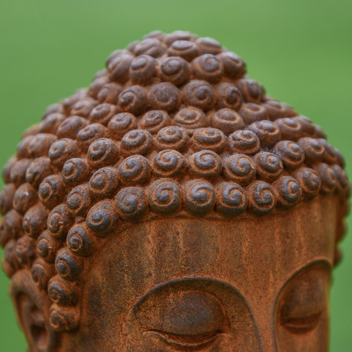 Close-up of the Detail on the Rustic Cast Iron Buddha Sculpture
