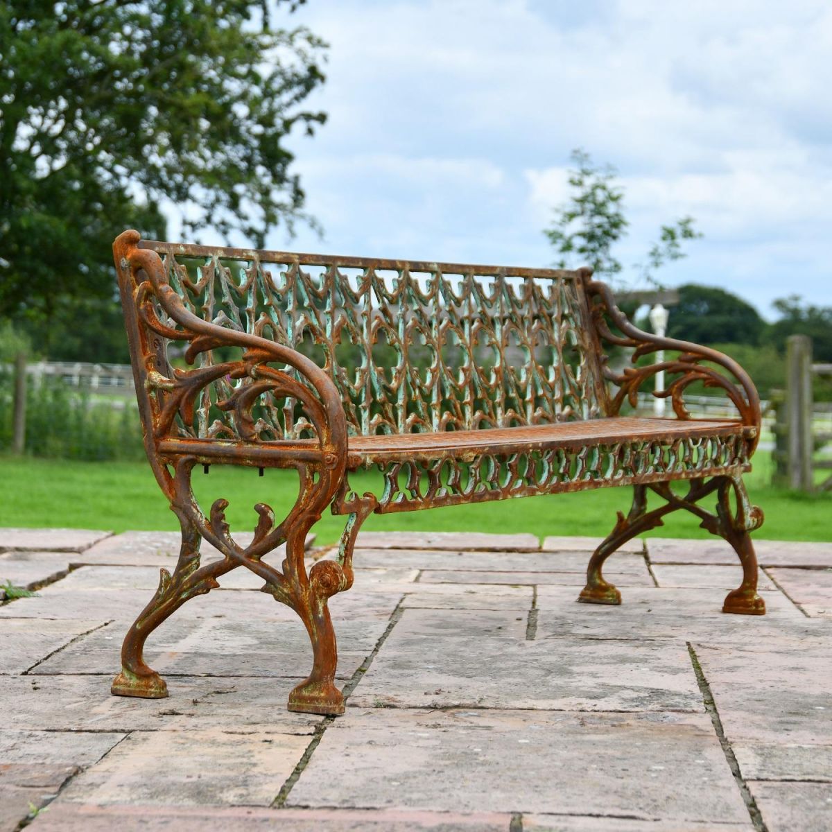 Close up of Rustic Three Seater Garden Bench with Victorian Detailing 