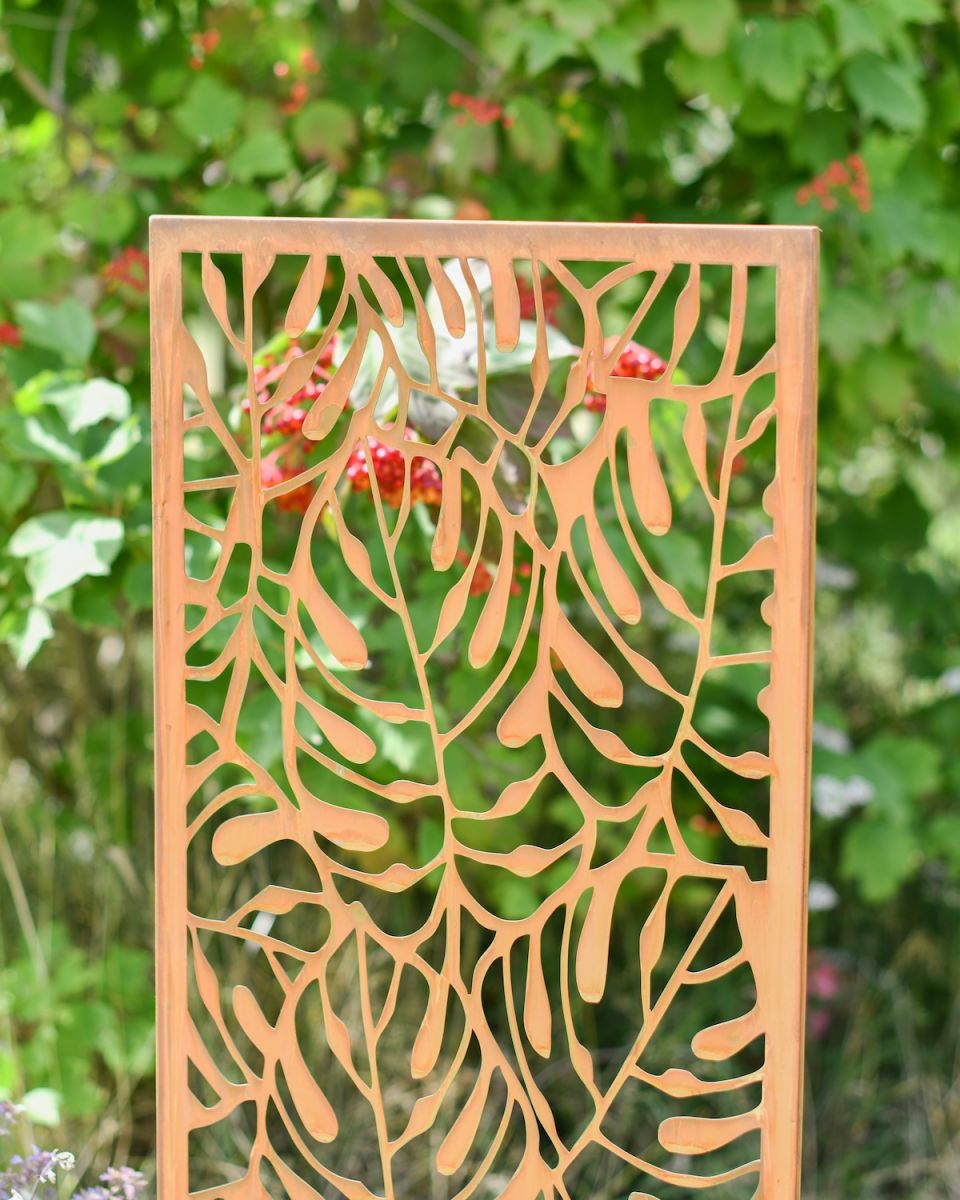 Close up of intricate cut out detail on rustic garden screen