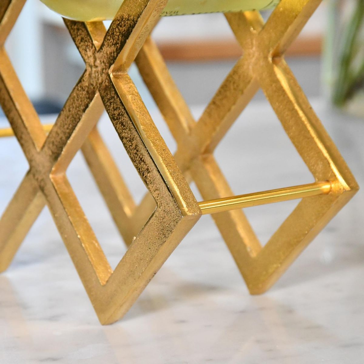 Close up of gold geometric grid wine rack 