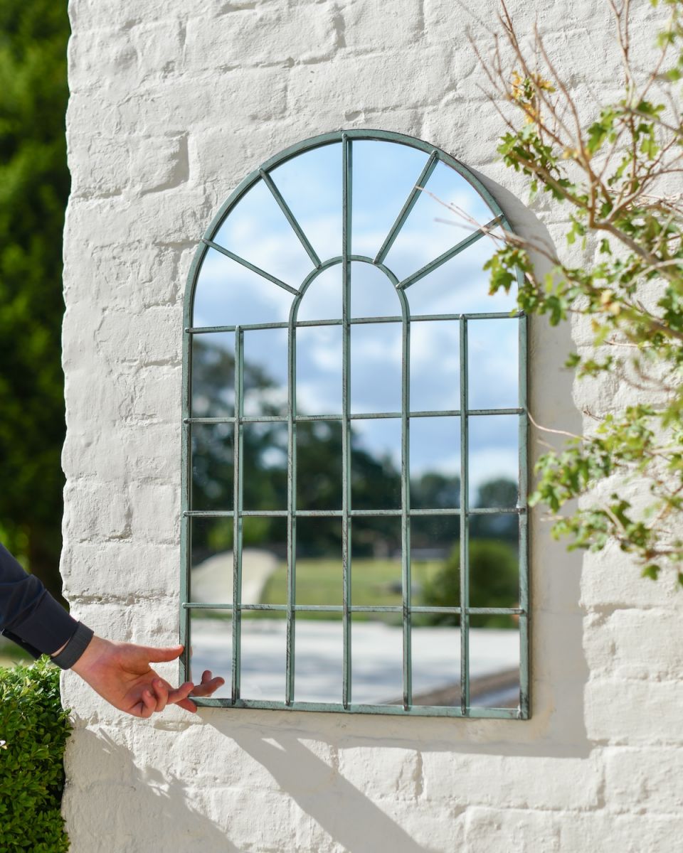 Scale image of arched garden mirror with metal frame