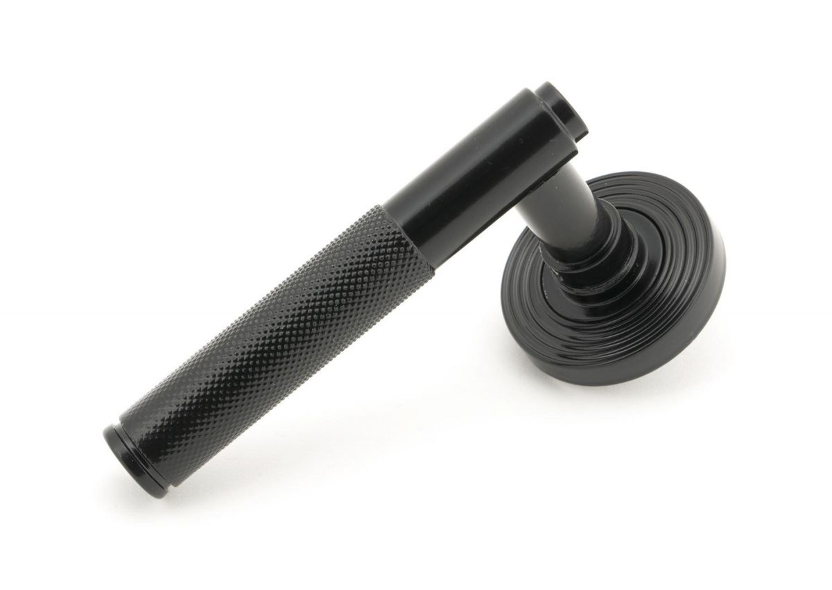 Sleek Black Textured Unsprung Lever Door Handle on Beehive Rose Handle