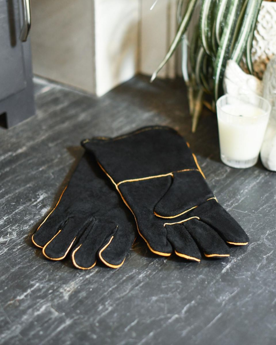 Suede Black & Orange Fireside Gloves Next To A Fire
