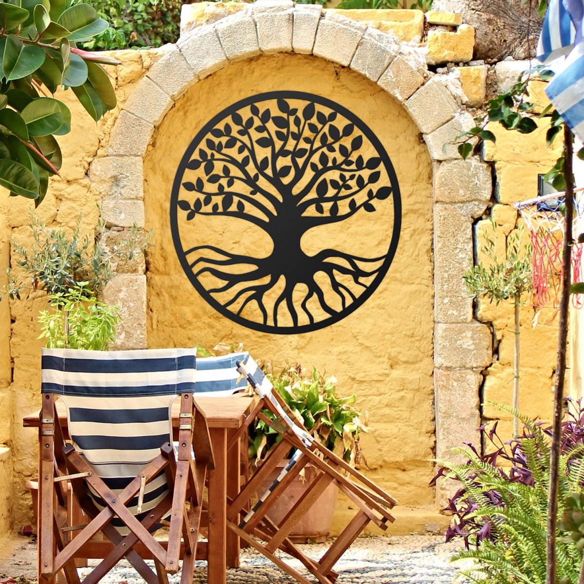 Black Round "Tree of Life" Wall Art in the Garden