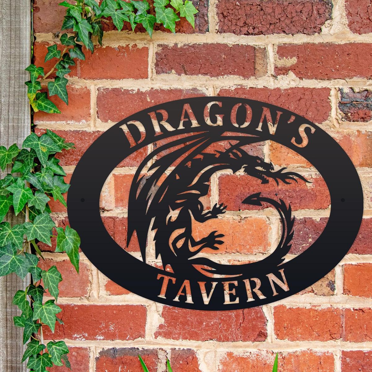 Tribal Dragon Iron Oval House Sign on a Brick Wall