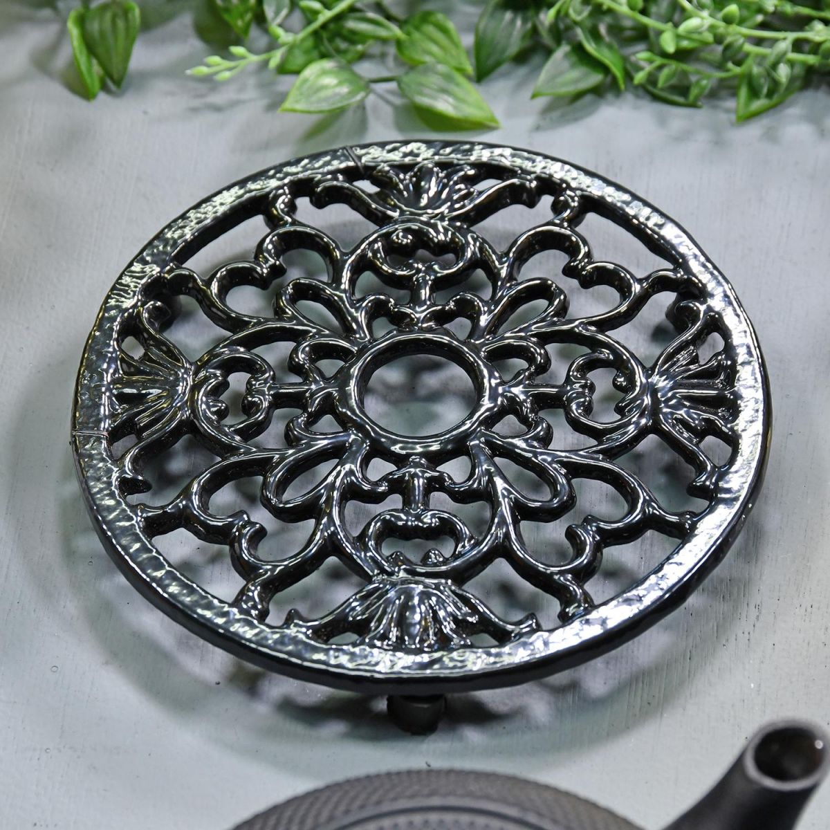 Black Heavy Duty Cast Iron Round Trivet in Situ in the home