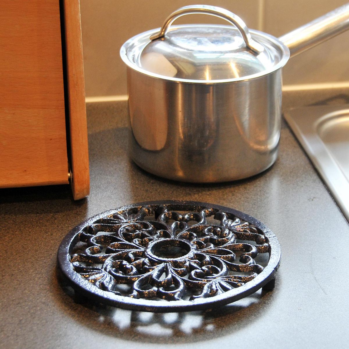 Black Heavy Duty Cast Iron Round Trivet in Use in the Kitchen