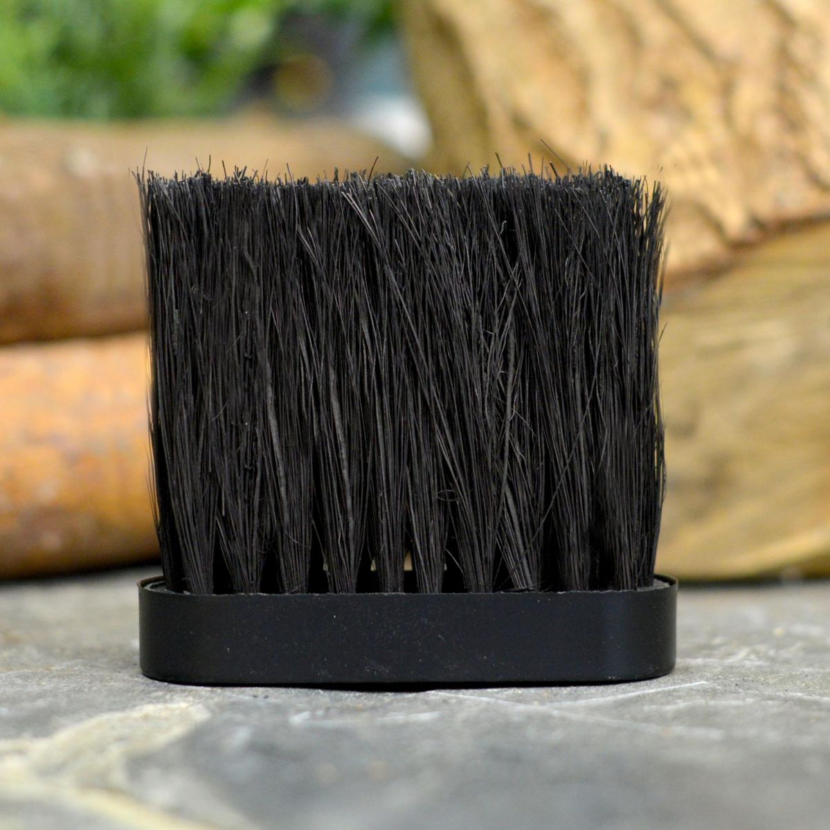 Replacement Oblong Fireside Brush Head Next to Fireside Logs