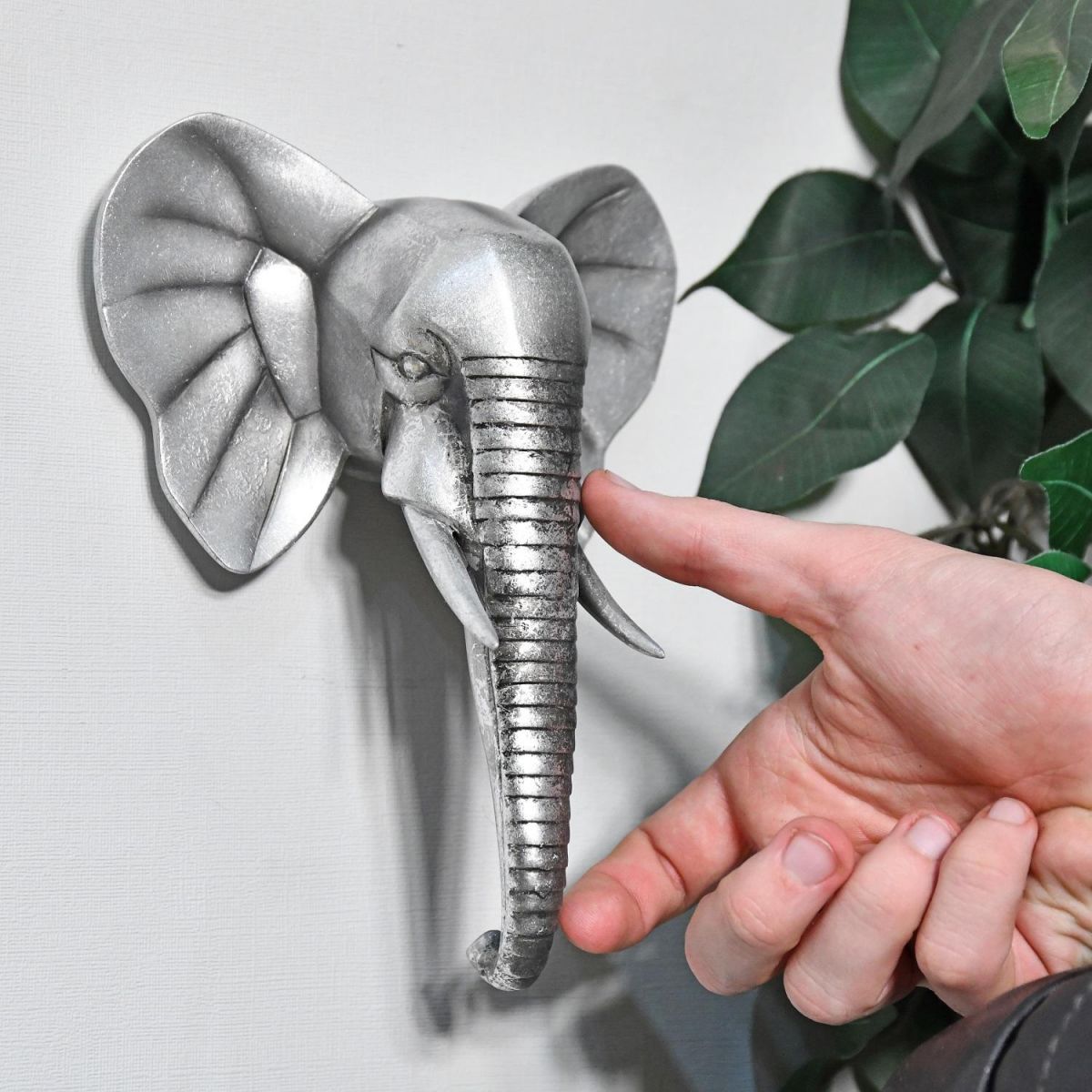 Elephant Wall Art in Silver with hand for scale 