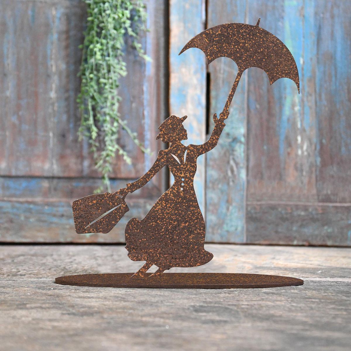 Mary Poppins Rustic Iron Door Stop in Front of a Rustic Blue Door