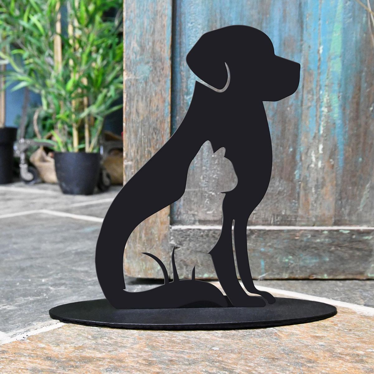 Cat & Dog Iron Door Stop Next to a Rustic Blue Door