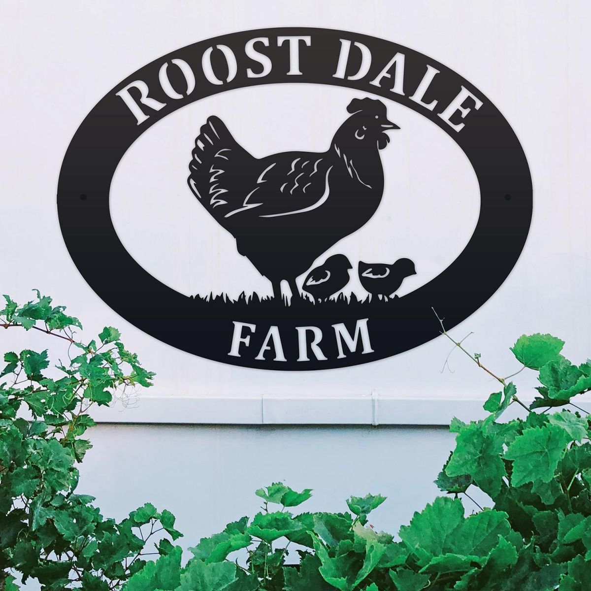 Hen & Chicks Iron Oval House Sign on a White Wall
