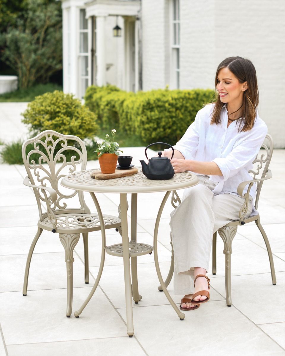 Woman Sat at Champagne Garden Furniture Set 