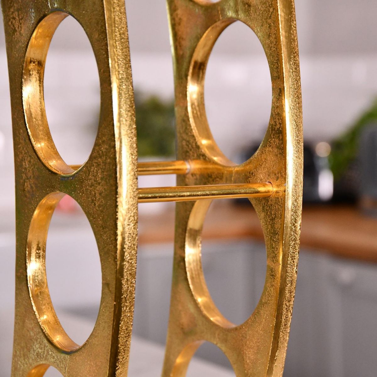 Close up of gold wine rack 