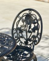 Close up of ornate detail on chair backrest on garden furniture set