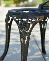 Close up of ornate detail on chair leg garden two seater table and chairs set