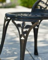 Close up of intricate chair leg detail on outdoor bistro set
