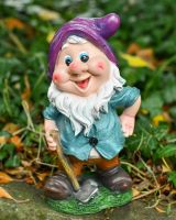 Angled view of colourful garden gnome statue