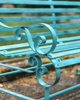 Close-Up of Ornate Armrest for Green “Chatham" Two Seater Park Bench