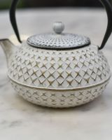 Close up of "Agawa" White Finish Cast Iron Japanese Style Teapot detailing