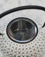 Close up of "Agawa" White Finish Cast Iron Japanese Style Teapot strainer