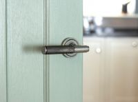 Aged Pewter Textured Unsprung Lever Door Handle on Art Deco Rose on Door