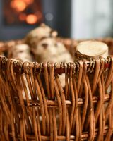 Close-Up of Aged Wicker Log Basket with Metal Handles in Situ