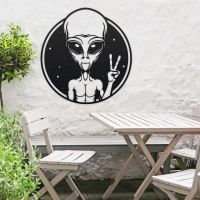 Peace Sign Alien Wall Art in Situ Above a Wooden Garden Furniture Set
