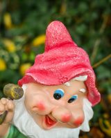 Close up of intricate hat detail on colourful garden gnome sculpture