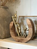 Angled close up of gold figures on interior art sculpture