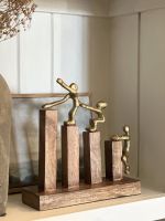 Angled view of gold figure home decor accessory