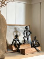 Angled view of "Fireside" Cast Aluminium & Mango Wood Sculpture - Black