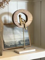 Angled view of gold figure home decor sculpture