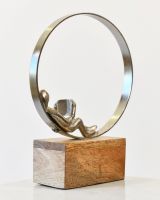 Angled view of cast aluminium and mango wood home decor sculpture