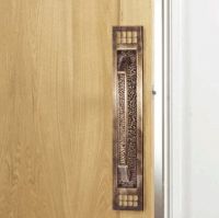 Large Antique Brass Door Pull Handle in Situ on Wooden Door