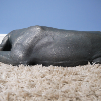 Close-up of the Antique Bronze Finish on the Laying Dog Sculpture