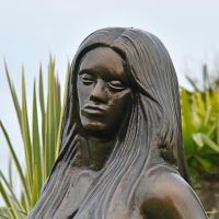 Close-up of the Antique Bronze Face on the Mermaid Garden Sculpture