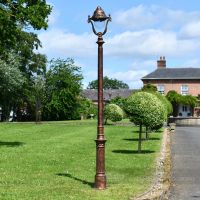 Antique Copper Finish Opulent Cast Iron Lamp Post Infront of Period Proprty