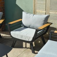 Close up of individual armchair on modern black five seater outdoor sofa set